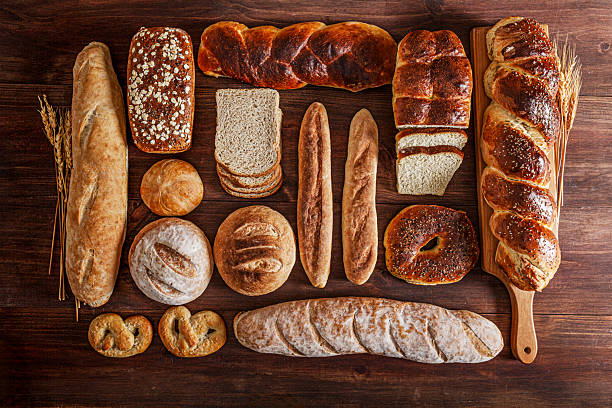 Assorted artisan breads on rustic wooden table